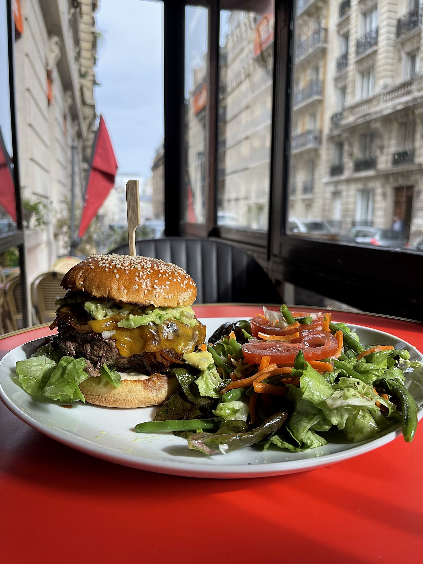 Le burger maison, cheddar fondant et salade croquante, servi en terrasse.